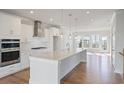 Bright, open kitchen featuring a large island, stainless steel appliances, and hardwood floors at 1030 Burnside Nw Pl, Atlanta, GA 30318