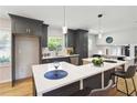 Modern kitchen featuring an island with counter seating, pendant lights, and sleek cabinetry at 2158 Oregon Ct, Decatur, GA 30032