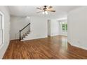 Spacious living room with hardwood floors, stairway, and natural light from ample windows at 3845 Pilgrim Mill Rd, Cumming, GA 30041