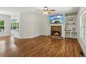 Bright living room features a stone fireplace, built-in shelves, and hardwood flooring at 3845 Pilgrim Mill Rd, Cumming, GA 30041