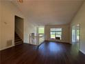 Bright living room with hardwood floors, staircase, and a view to the outside at 1100 Whistle Dr, Austell, GA 30106