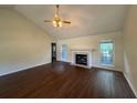 Spacious living room featuring hardwood floors, a fireplace, and a ceiling fan at 1100 Whistle Dr, Austell, GA 30106