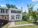 Inviting two-story townhouse with dark shutters, freshly painted white exterior and a lovely green lawn at 1505 Cedar Bluff Trl, Marietta, GA 30062