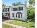 Beautiful two-story townhouse featuring an inviting entrance, dark shutters, and a lush green lawn at 1505 Cedar Bluff Trl, Marietta, GA 30062