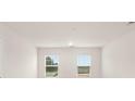 Serene bedroom with two windows offering natural light and views of the outdoors at 8605 Secretariat Dr, Lithonia, GA 30058