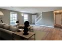 Inviting living room featuring new floors, neutral walls and bright natural light at 1282 Berryhill Dr, Lithonia, GA 30058