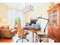 Well-lit home office featuring hardwood floors, a large window, and stylish decor at 1996 Cobblestone Ne Cir, Atlanta, GA 30319