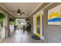 Inviting covered front porch featuring a ceiling fan, seating area, and bright yellow door with East Lake sign at 2486 Memorial Se Dr, Atlanta, GA 30317