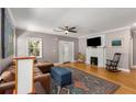 Inviting living area featuring hardwood floors, a decorative fireplace, and elegant French doors at 2486 Memorial Se Dr, Atlanta, GA 30317