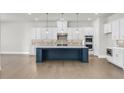 Spacious kitchen with an oversized island, stainless steel appliances and designer backsplash at 6660 Wallace Farms Dr, Cumming, GA 30028