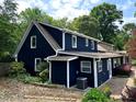 Rear exterior view of home featuring a well-maintained blue exterior with an established landscape design at 209 Hearthstone Reach, Peachtree City, GA 30269
