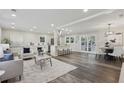 Open-concept living room with hardwood floors, lots of light, and a combined kitchen/dining area at 5421 Brownlee Rd, Stone Mountain, GA 30087