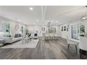 Spacious open-concept living room features luxury vinyl plank flooring, a combined kitchen and dining area, and modern finishes at 5421 Brownlee Rd, Stone Mountain, GA 30087