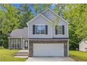 Beautiful home with a two-car garage, manicured lawn, and traditional design elements at 9511 Rollinghills Dr, Jonesboro, GA 30238