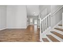 Bright living room with hardwood floors leading to the stairs and kitchen at 9511 Rollinghills Dr, Jonesboro, GA 30238