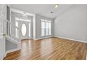 Spacious living room featuring hardwood floors and a bright entry door at 9511 Rollinghills Dr, Jonesboro, GA 30238