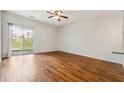 Open living area featuring hardwood floors, lots of sunlight, and sliding door access at 1363 Penhurst Dr, Lawrenceville, GA 30043