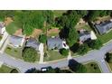 Aerial view of a neighborhood showcasing well-maintained homes and landscaped yards, with lush greenery at 260 Ruby Forest Pkwy, Suwanee, GA 30024