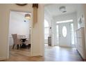 Bright foyer with hardwood floors, white walls, and a view into the dining room at 260 Ruby Forest Pkwy, Suwanee, GA 30024