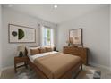 Inviting bedroom with neutral tones, a wooden bed frame, side tables, and modern artwork at 3178 Birdsong Ave, Covington, GA 30016
