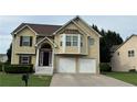 Traditional two-story home features a two-car garage, brick-accented entrance, manicured lawn and decorative trim work at 51 Freedom Ne Dr, Cartersville, GA 30121