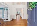 Open foyer with hardwood floors and classic columns leading to the living area at 1915 Milfield Cir, Snellville, GA 30078