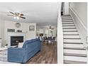 Inviting living room with a fireplace, hardwood floors, and an adjacent staircase at 26 Springbottom Dr, Lawrenceville, GA 30046