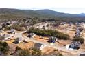 Expansive aerial view showcasing a well-planned community nestled amidst lush greenery and rolling hills at 33 N Village Cir, Rydal, GA 30171