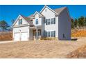 Beautifully designed home with a two-car garage and a landscaped front yard creating curb appeal at 33 N Village Cir, Rydal, GA 30171