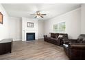 Spacious living room with a fireplace, hardwood floors, and large window providing natural light at 33 N Village Cir, Rydal, GA 30171