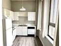 Functional kitchen with white cabinets, appliances, and ample counter space at 20 Marietta Nw St # 7C, Atlanta, GA 30303