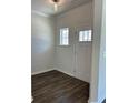 Bright foyer with hardwood flooring, a front door with glass panel, and a modern ceiling light at 3706 Cheswolde Ave # 96, Powder Springs, GA 30127