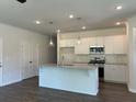 Bright kitchen featuring an island, stainless steel appliances, and white cabinets for a modern look at 3706 Cheswolde Ave # 96, Powder Springs, GA 30127