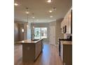 Modern kitchen with a large island, quartz countertops, stainless steel appliances, and pendant lighting at 3706 Cheswolde Ave # 96, Powder Springs, GA 30127