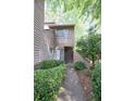 Charming townhome showcasing landscaped walkway leading to the front door at 1606 Parkaire Xing # 1606, Marietta, GA 30068