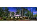 Charming brick home with lush landscaping and a covered carport, beautifully captured at twilight at 561 Sybil Se Ln, Marietta, GA 30067
