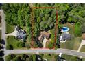 Aerial view of property showing the house, yard, pool and surrounding trees at 7401 Cherry Blossom Way, Winston, GA 30187