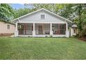 Inviting home with a classic screened-in porch and well-maintained lawn at 1591 Jonesboro Se Rd, Atlanta, GA 30315