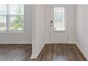 Bright foyer with wood flooring, a glass-paneled door, and a large window at 3825 Sycamore Hill Dr, Loganville, GA 30052