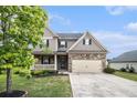 Charming two-story home with a stone facade, two-car garage, and well-manicured lawn at 13 Cottage Nw Walk, Cartersville, GA 30121