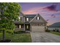 Charming home with stone accents, a front porch, manicured lawn, and an attached two-car garage at sunset at 13 Cottage Nw Walk, Cartersville, GA 30121