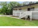 Welcoming home with a white lattice-covered porch, a walkway to the entrance, and vibrant green grass at 4170 Maroney Mill Rd, Douglasville, GA 30134