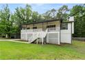 Attractive home with a white lattice-covered porch, complemented by a lush green lawn and mature trees at 4170 Maroney Mill Rd, Douglasville, GA 30134