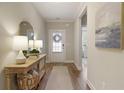 Inviting entryway features hardwood floors and stylish decor with lamps and mirror at 714 Chipping Sparrow St, Canton, GA 30115