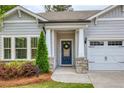 Close-up of front door with stone accents, address number and lovely wreath at 714 Chipping Sparrow St, Canton, GA 30115