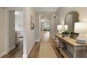 Spacious hallway leading to various rooms with neutral walls and stylish decor at 714 Chipping Sparrow St, Canton, GA 30115