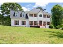 Charming two-story home featuring a white exterior, wood shutters, and a well-maintained front lawn at 17 Hiram Way, Hiram, GA 30141