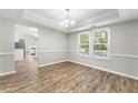 Dining room featuring light gray walls, modern flooring, white trim, and a large window for natural light at 194 Beaverwood Ct, Lawrenceville, GA 30044