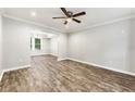 Bright, open living room with hardwood floors, white trim and crown molding, and a ceiling fan at 194 Beaverwood Ct, Lawrenceville, GA 30044