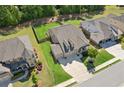 Expansive aerial view of a brick home, showcasing the well-maintained yard, and surrounding neighborhood at 2470 Crimson Downs Dr, Cumming, GA 30040